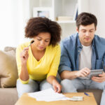 Couple researching DIY debt consolidation