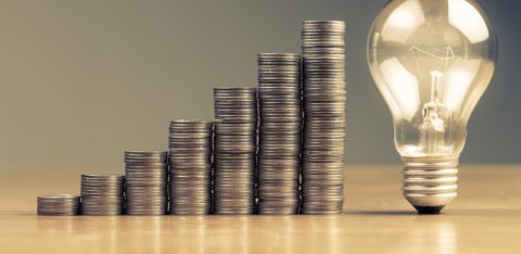 stack of coins leading up to light bulb min