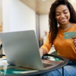 happy woman holding credit card