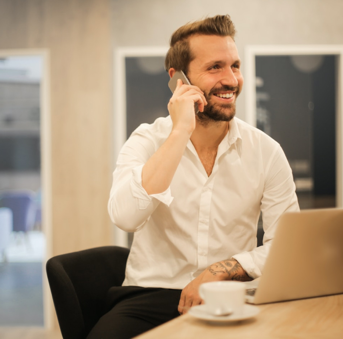 man talking on a phone at a desk