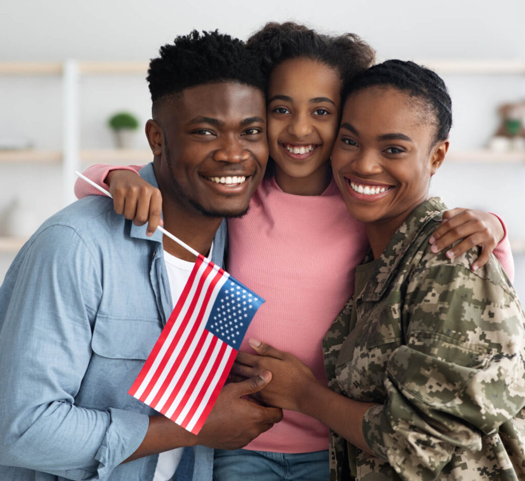 happy girl with flag of us hugging her parents