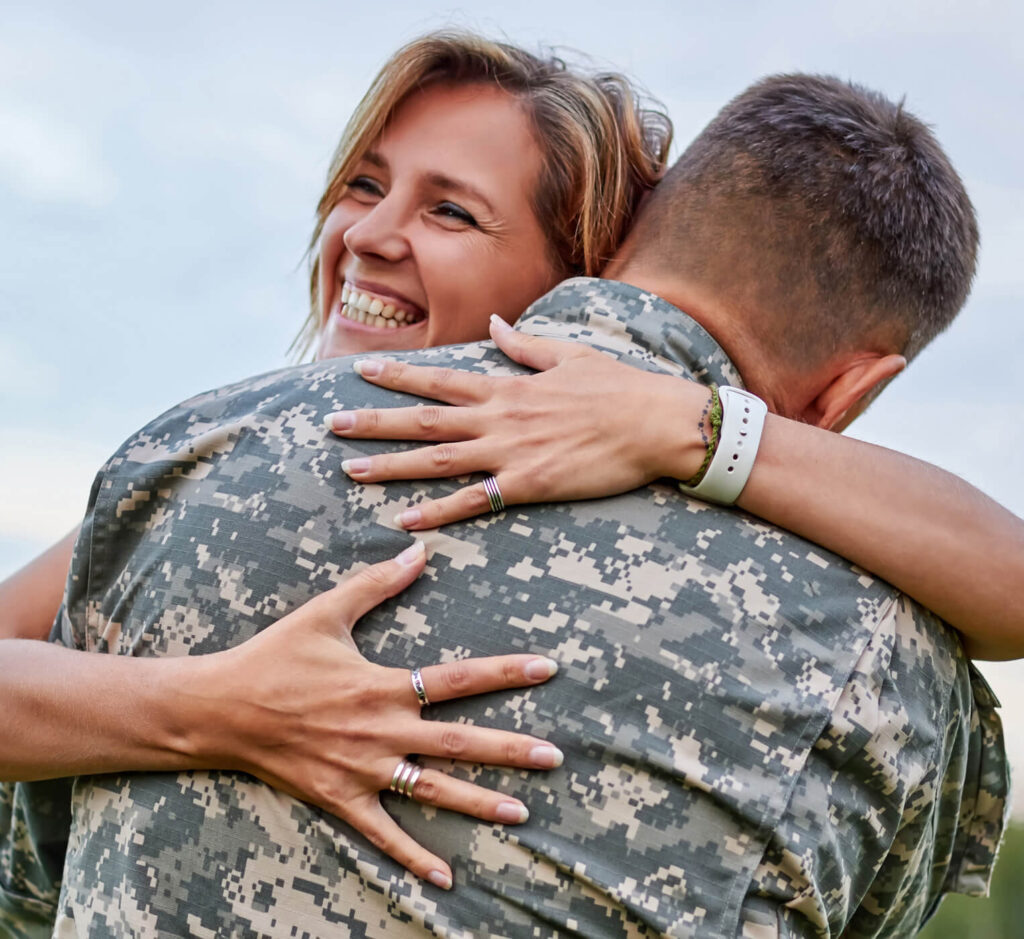 happy woman hugging his husband came back from arm