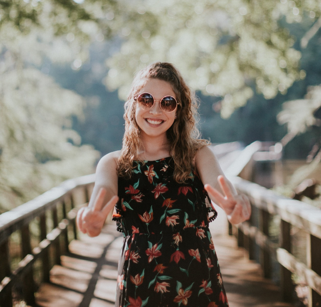 Woman on a bridge smiling