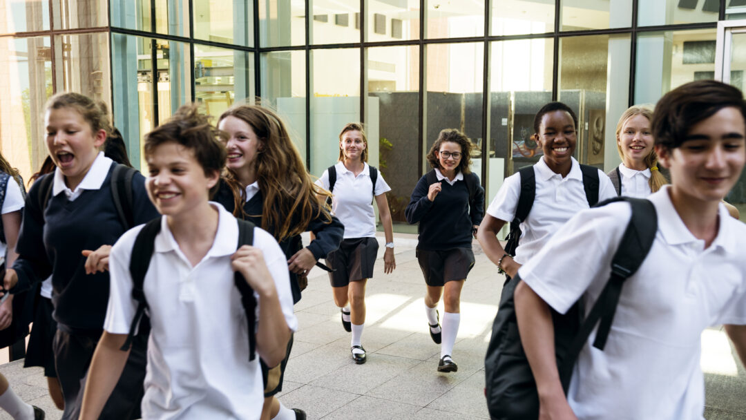 Group of students running at school