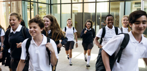 Group of students running at school