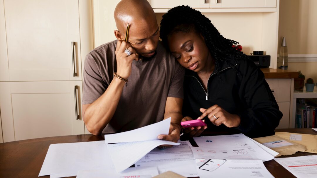 man and woman surrounded by bills