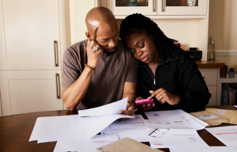 man and woman surrounded by bills