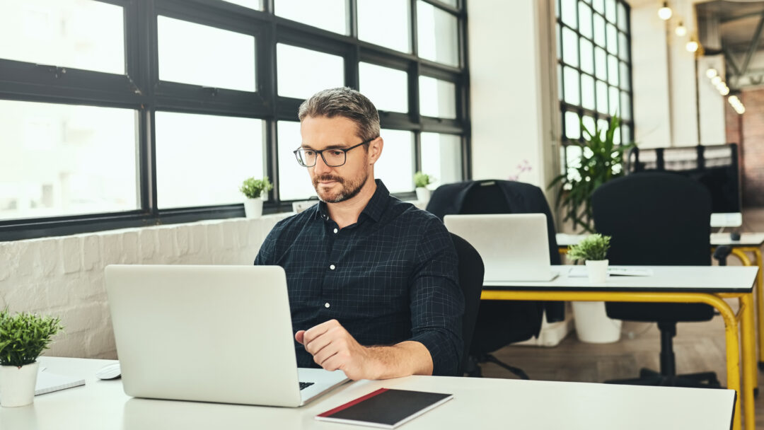 Man at an office desk working on computer