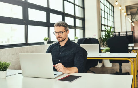 Man at an office desk working on computer