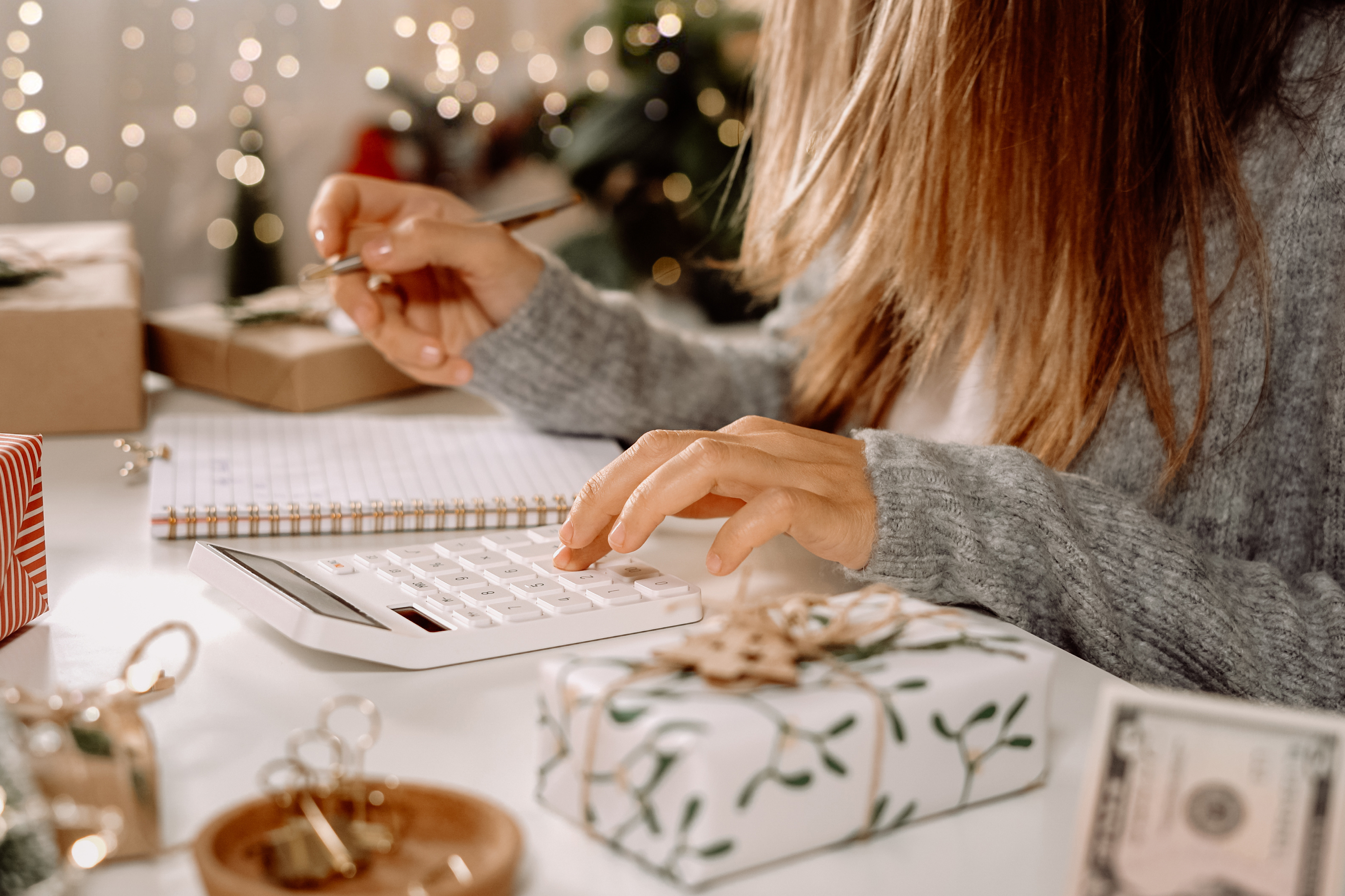 Woman doing holiday budget on calculator