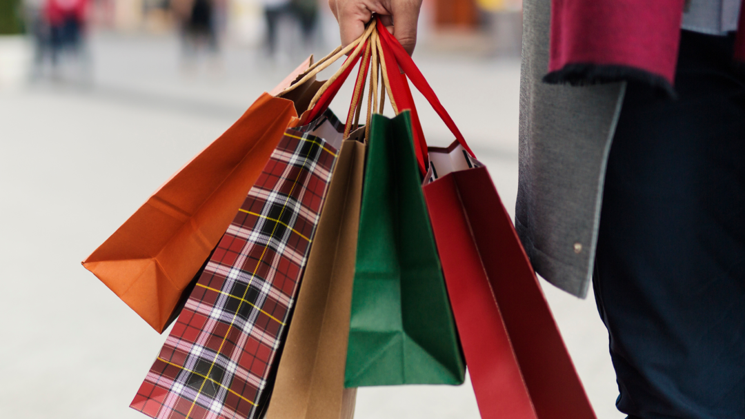 hand holding holiday shopping bags