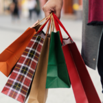 hand holding holiday shopping bags