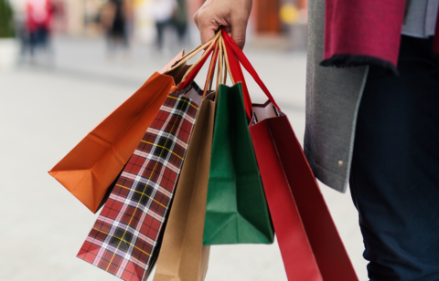 hand holding holiday shopping bags