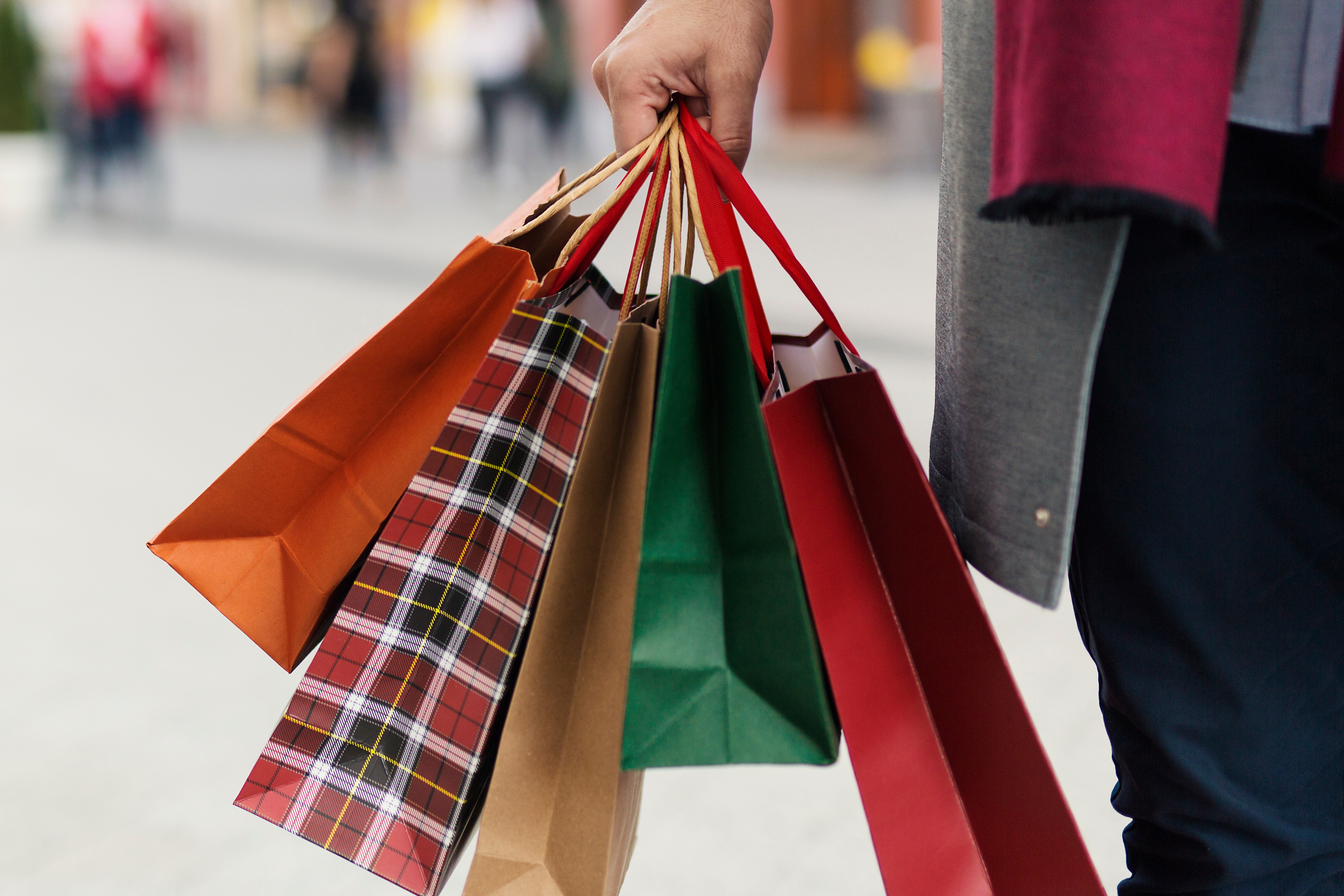 hand holding holiday shopping bags