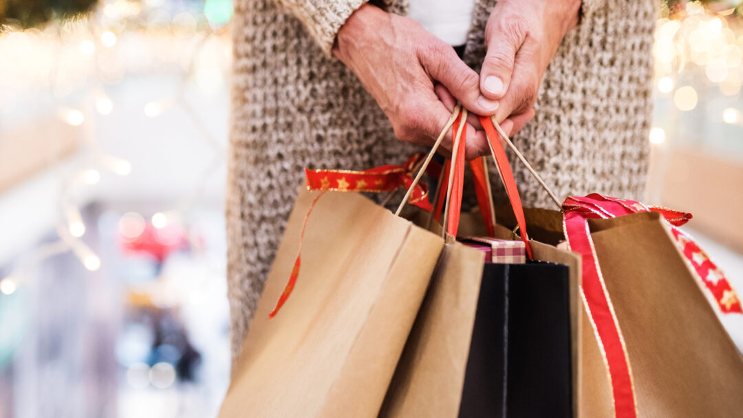 person holding shopping bags