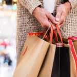 person holding shopping bags